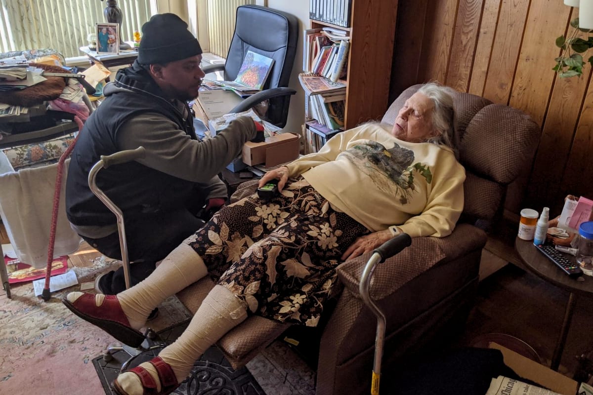 Technician Andre helping an elderly lady with her lift chair in her home