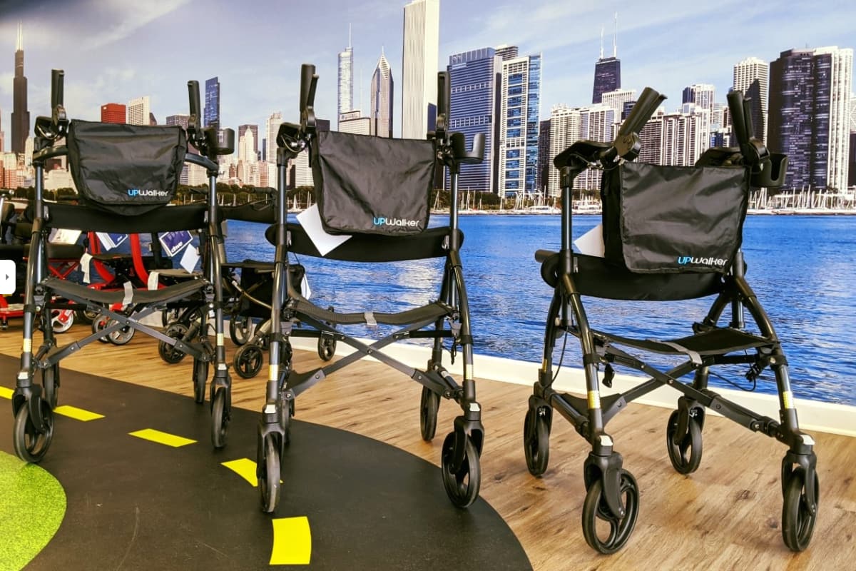 Three walkers on the showroom floor in front of a Chicago skyline mural