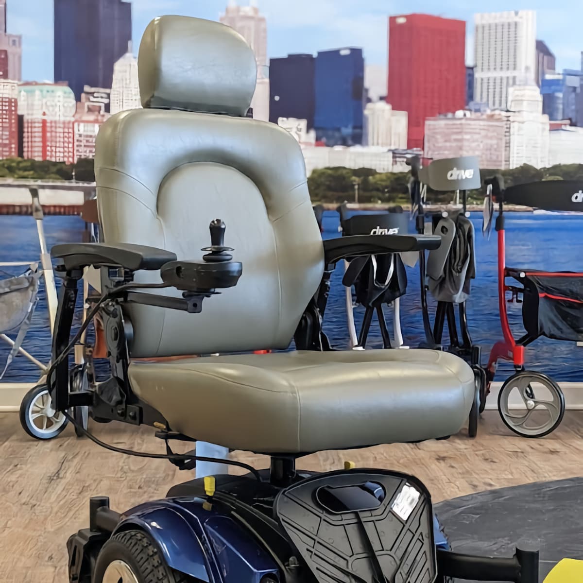 Used Golden Compass Sport power wheelchair with blue accents in Midwest Mobility showroom