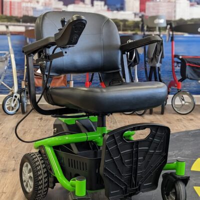 Used Golden LiteRider Envy power wheelchair with bright green accents in Midwest Mobility showroom