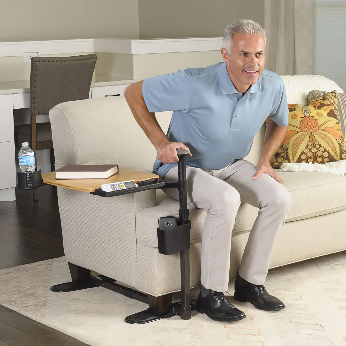 man using Signature Life Tray Table to help him lift himself from a couch