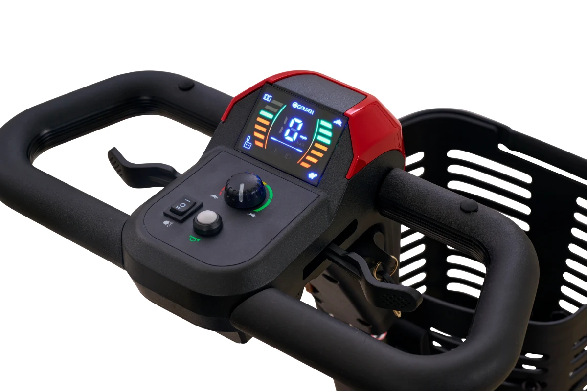 A close-up of the controls on the Golden Buzzaround XL Plus mobility scooter tiller. It features a digital display showing speed and battery life, a speed adjustment knob, and switches for the lights and horn.