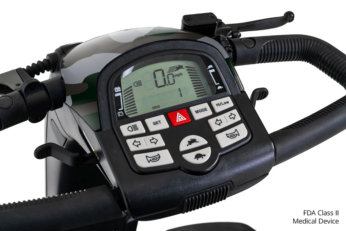 The control console of a mobility scooter, featuring a camouflage pattern, digital display, battery gauge, and various function buttons.